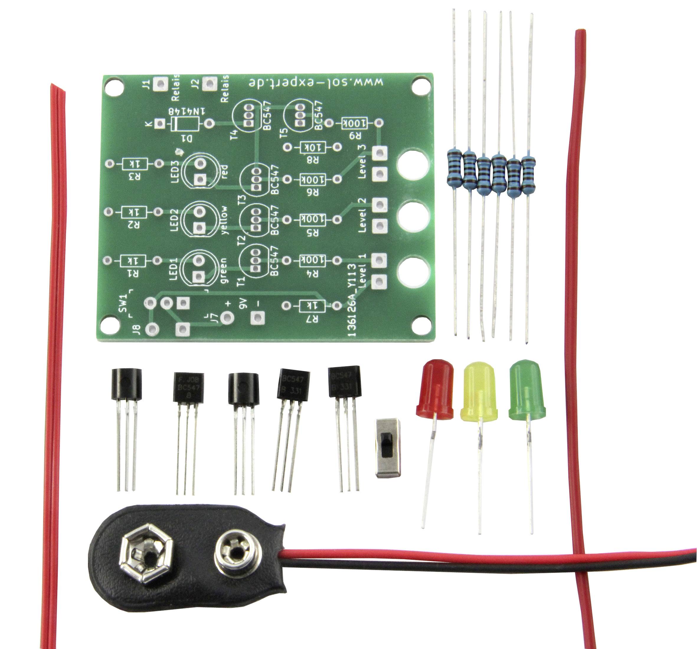Electronic kit with circuit board, resistors, transistors, LED lights, switch and battery clip, for self-assembly.
