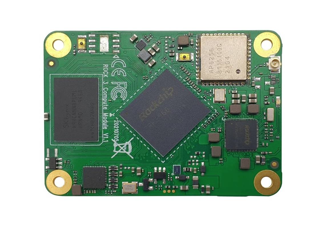 A small, green single-board computer module with various electronic components and chips, including a chip with the inscription 'ROCK' in the centre.
