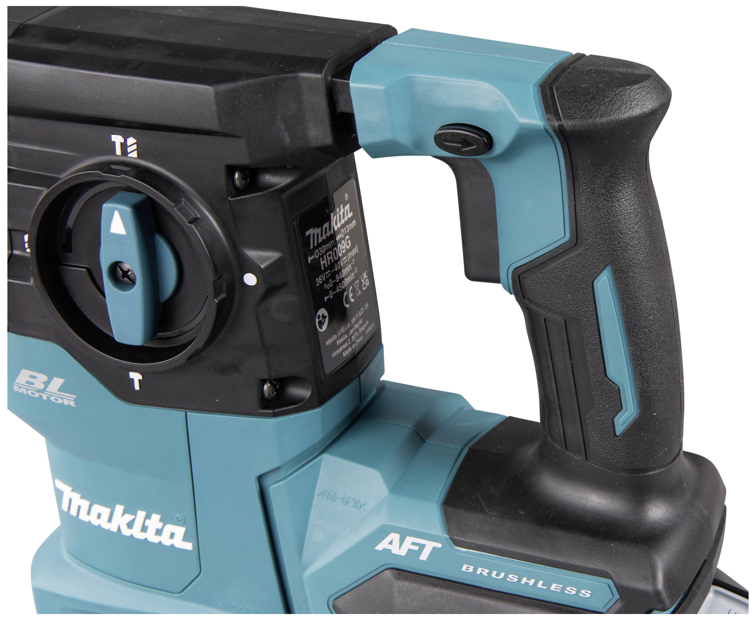 A green and black electric drill hammer with an ergonomic handle and controls.