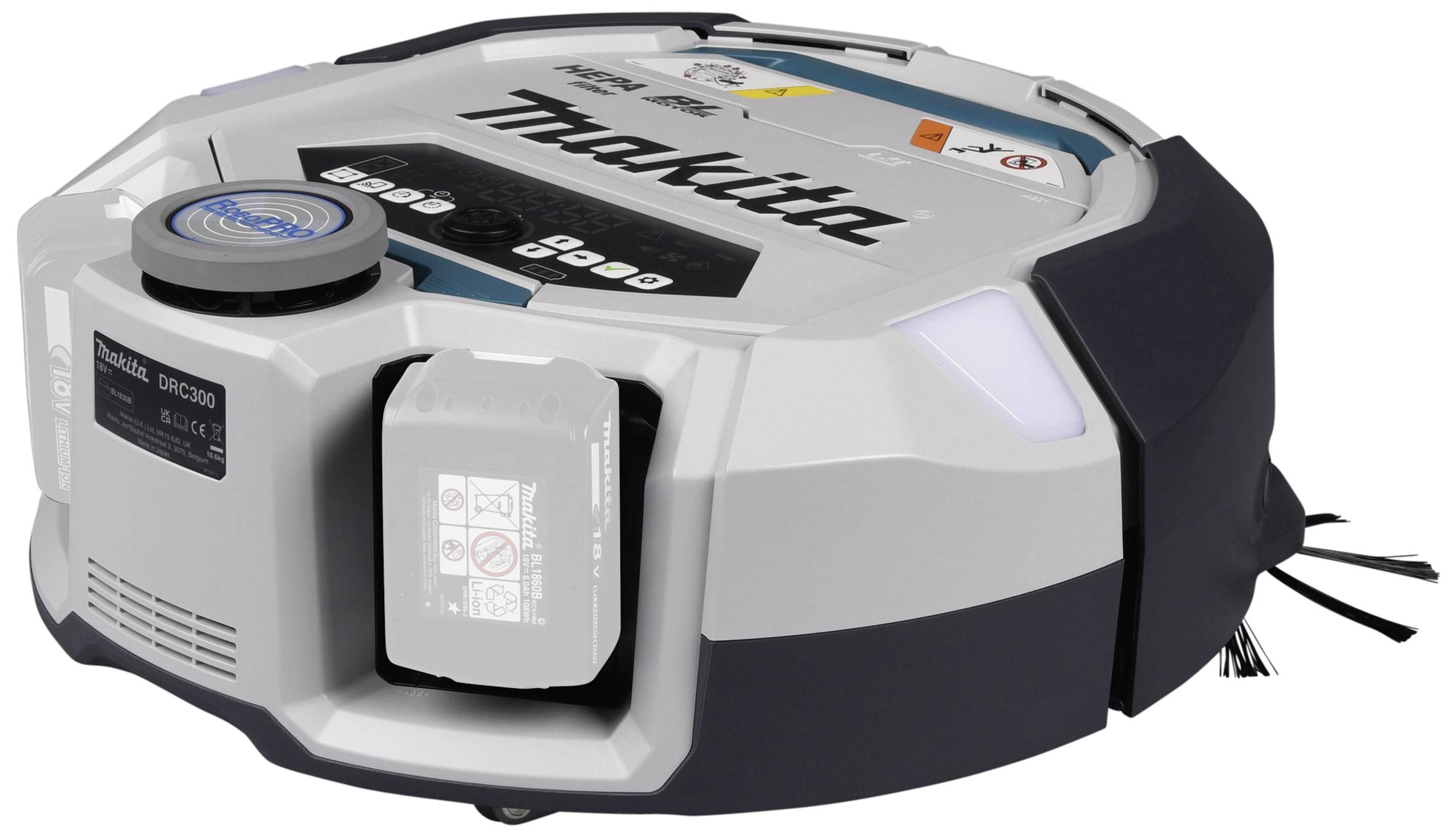 A silver, round vacuum cleaning robot with the 'Makita' print, showing its side brushes and a battery compartment on the top surface.