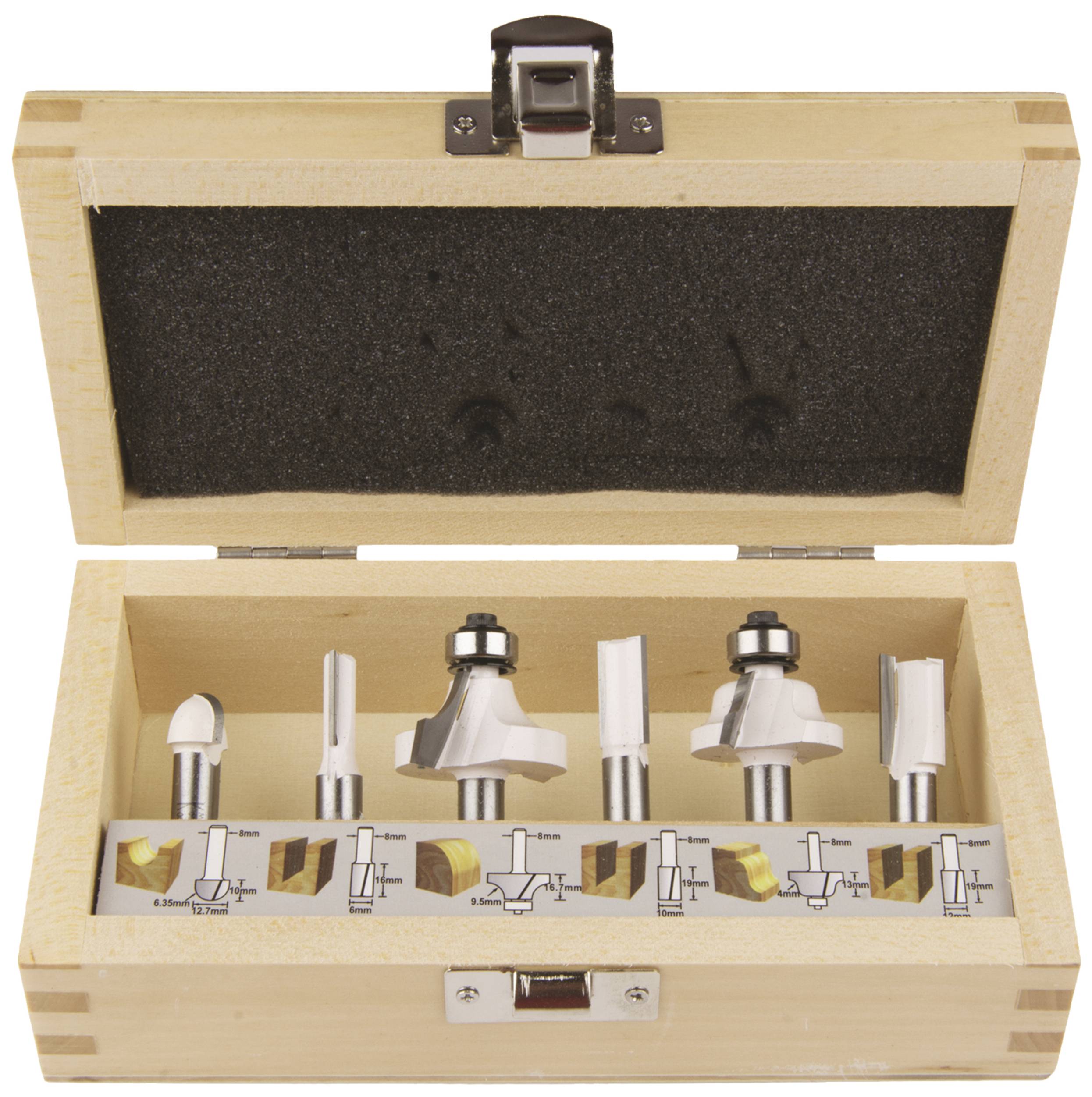 Wooden box with interchangeable router bits of various shapes and sizes. An illustrated guide shows the routing applications for wood.