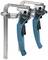 Two blue metal quick-release G-clamps standing side by side, with black handles and a rotary mechanism for securing workpieces.