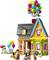 A colourful toy house with balloons on the roof, accompanied by two figures and a dog, all crafted from building blocks.