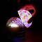 A hand holds a brightly coloured glowing sphere above a hexagonal pattern that also radiates colourful light.