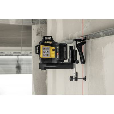 A laser device projects a red line onto a white wall, which is used for precise alignment during construction work.