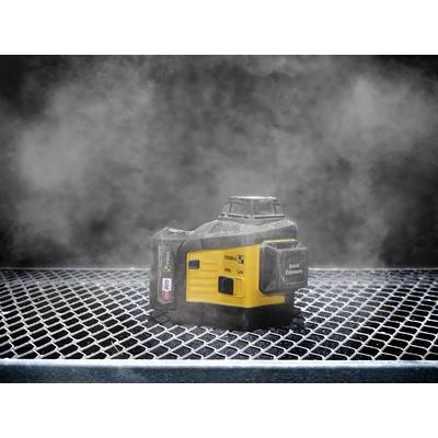 A yellow and black device sits on a wire mesh; surrounded by fine dust or smoke, it stands out against a dark background.