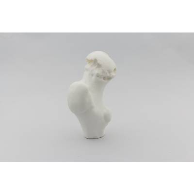 A white, abstract sculpture with a smooth, organic form. It stands upright against a neutral background.