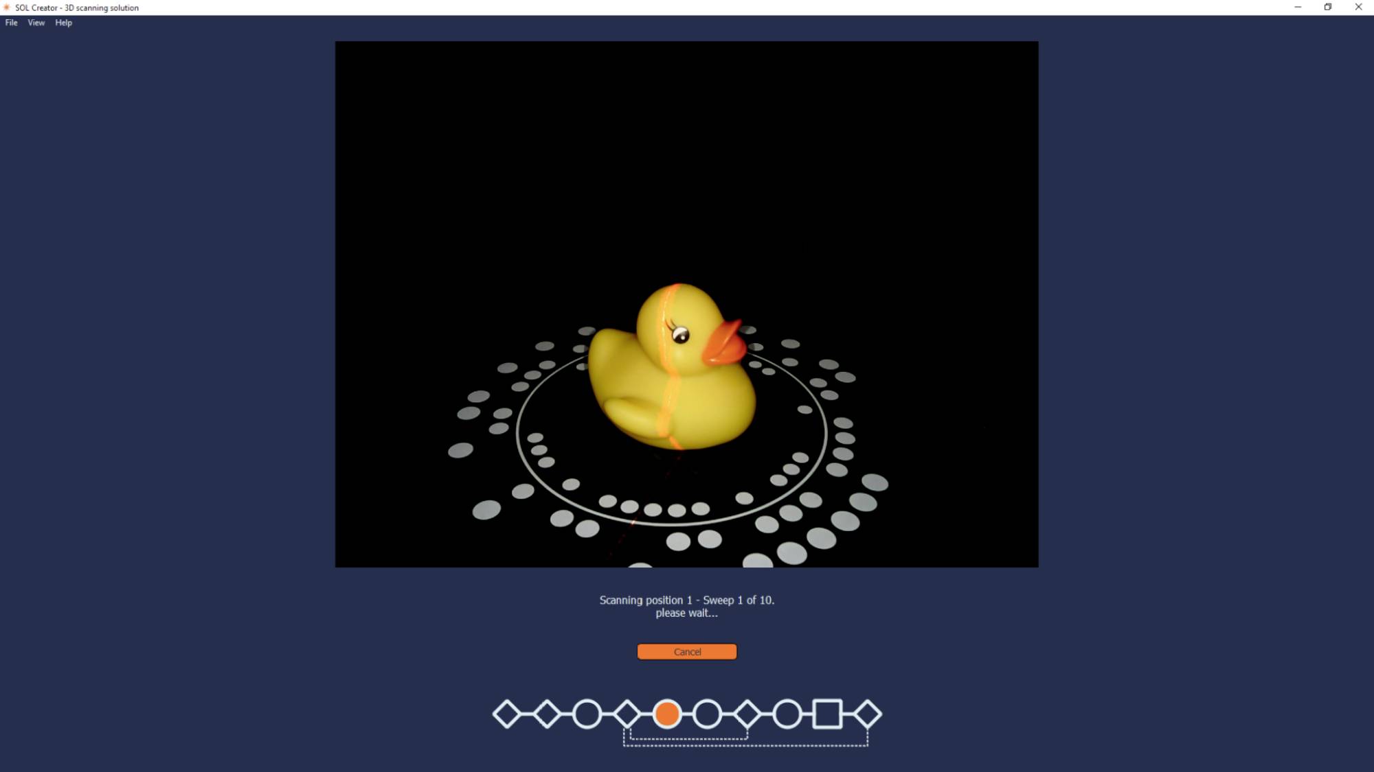 A yellow rubber duck sits in the centre of a circle of white dots on a black background. A progress bar is visible at the bottom.