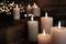 Several burning candles in front of a blurred background of lights. Atmospheric and soothing, suitable for relaxation.