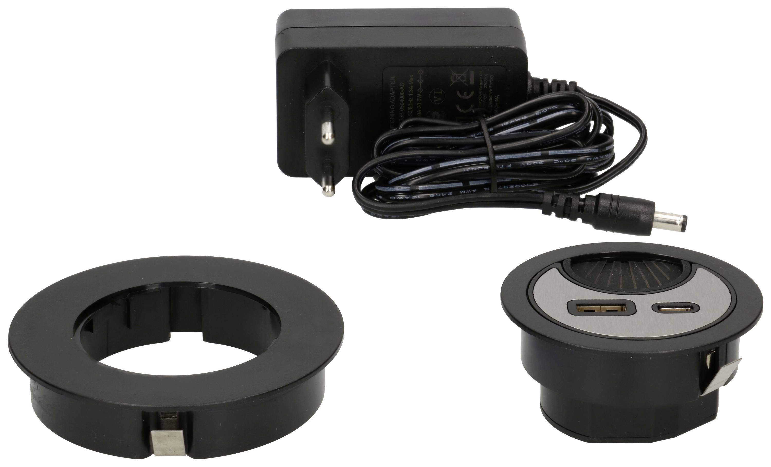 Black USB charging socket with matching charger. Two USB ports, round design. Charging socket is intended for integration into furniture.