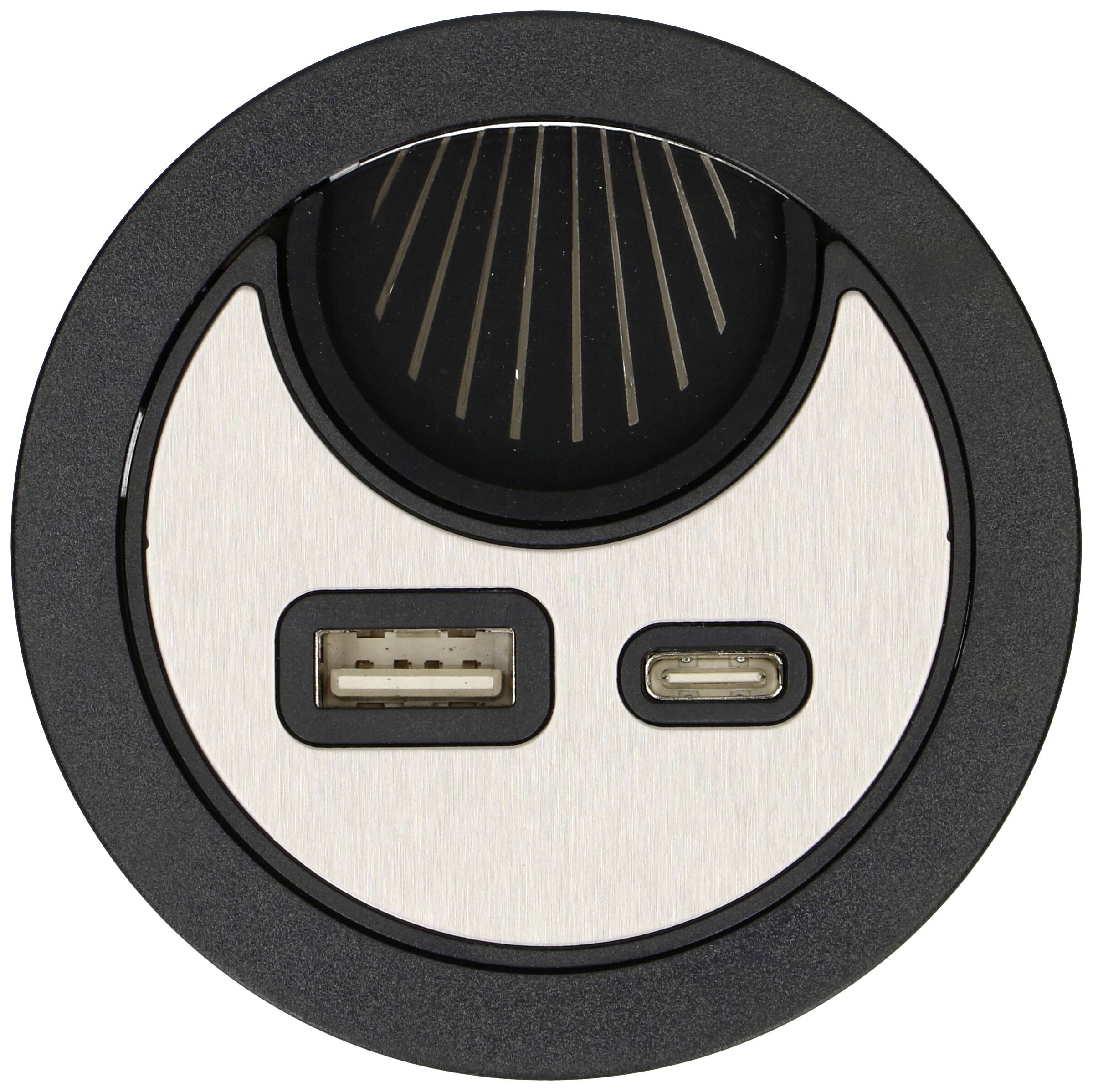 A round black power strip with two USB ports, one USB-A and one USB-C socket. Ideal for modern charging.