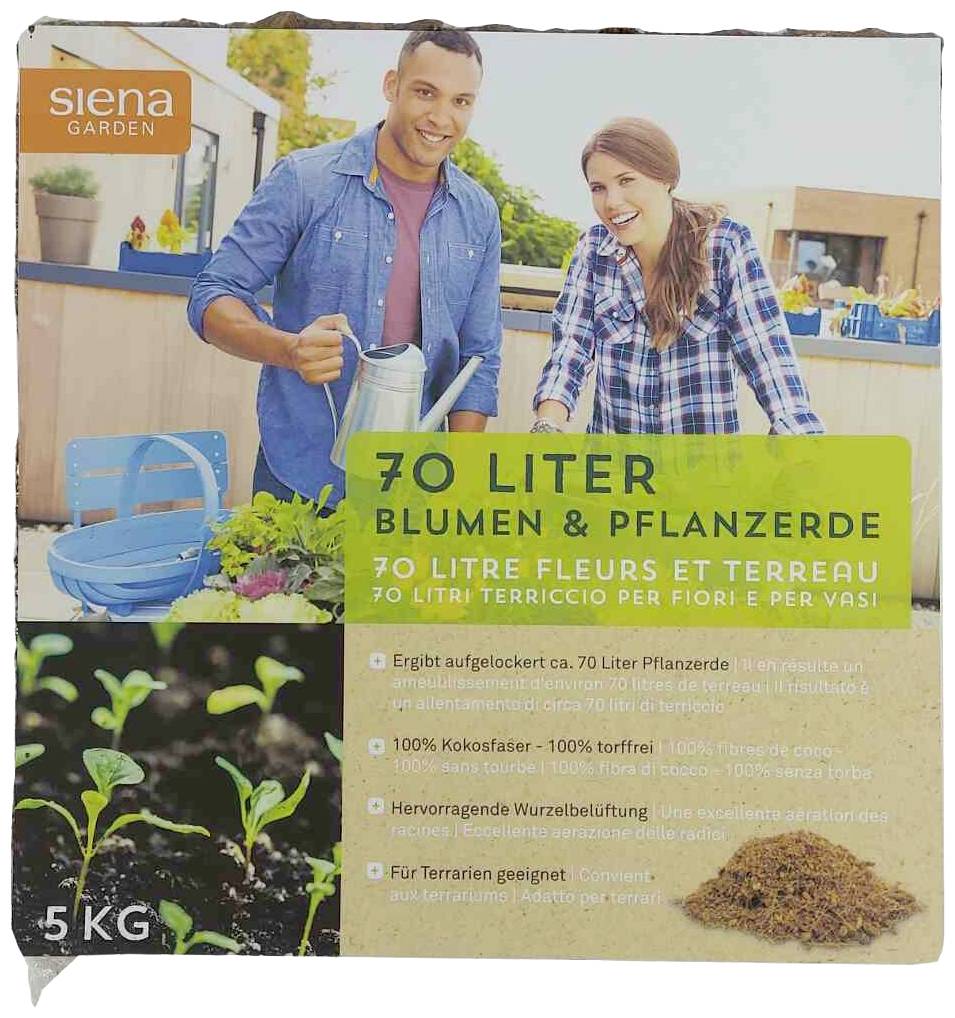 A man and a woman are working in the garden. A sack displays '70 litres of Flowers & Potting Soil'. In the foreground, germinating plants and garden soil.