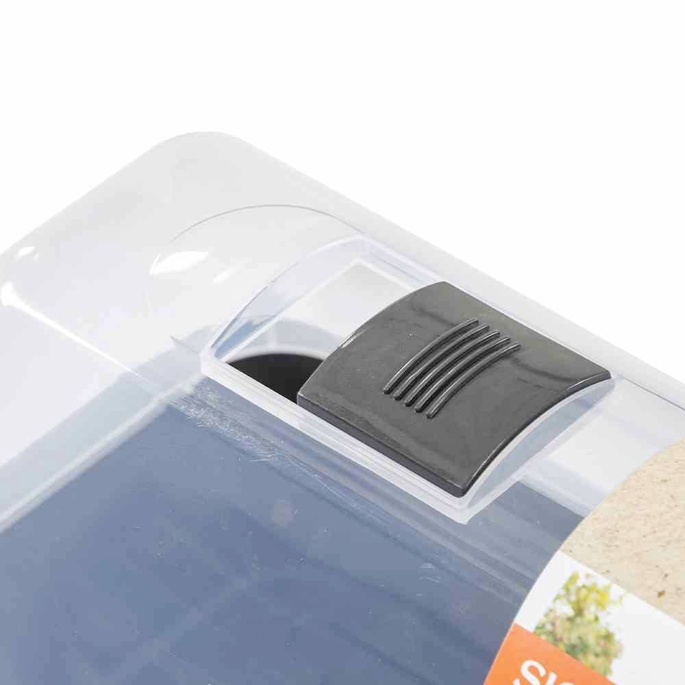A black switch on a transparent casing, possibly for controlling the box. An orange label section is visible.