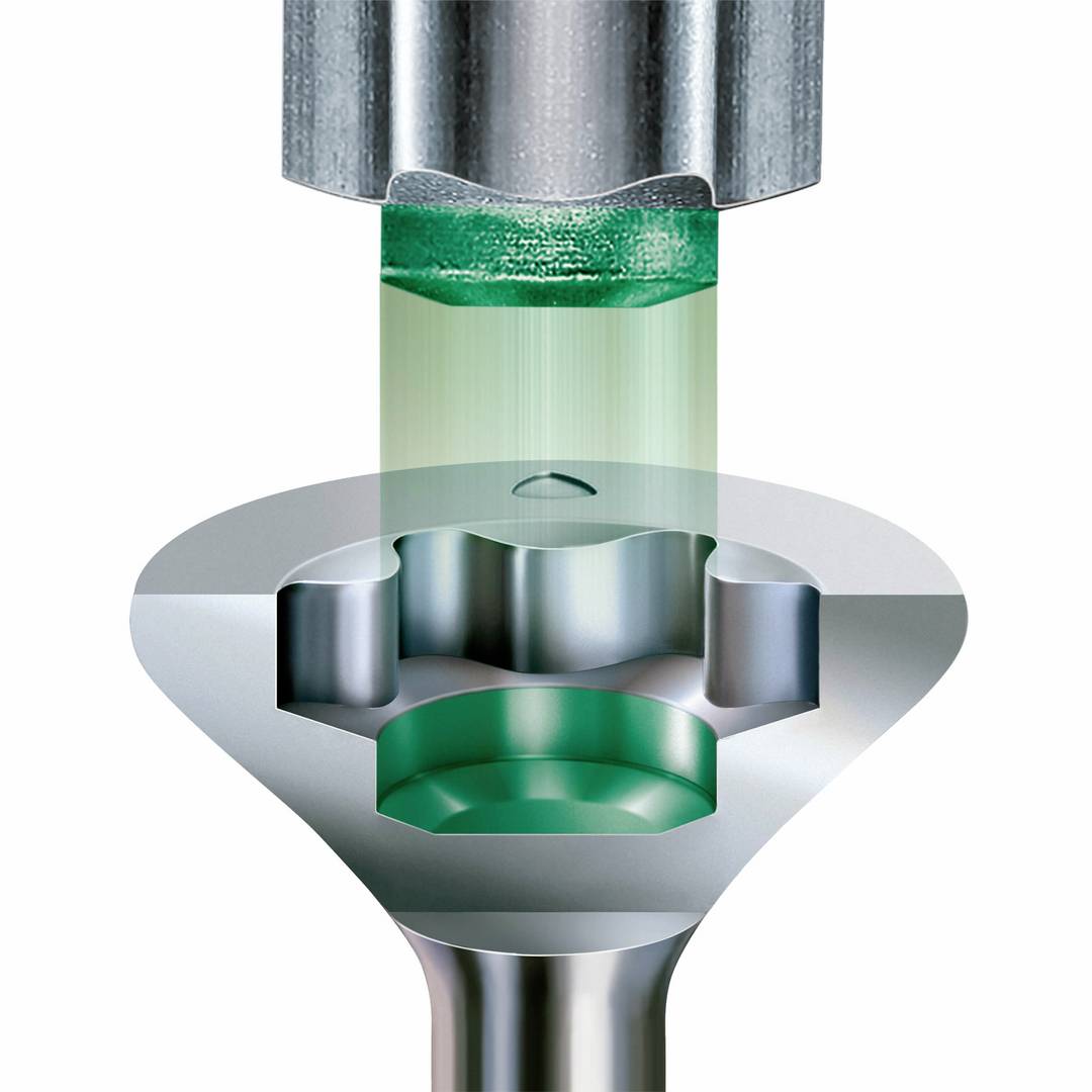 Close-up of a metallic tool with a multi-layered structure. Green elements appear to be penetrating through the layers, revealing a technological construction.