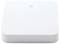 A white, square electronic device with minimal design and a small symbol positioned centrally at the top.