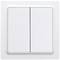 A white double light switch on a wall, used for controlling electrical devices or lighting.
