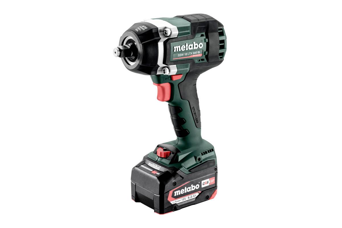 A green cordless impact driver by Metabo with a red button and black rubber grip. The device is pictured standing upright.