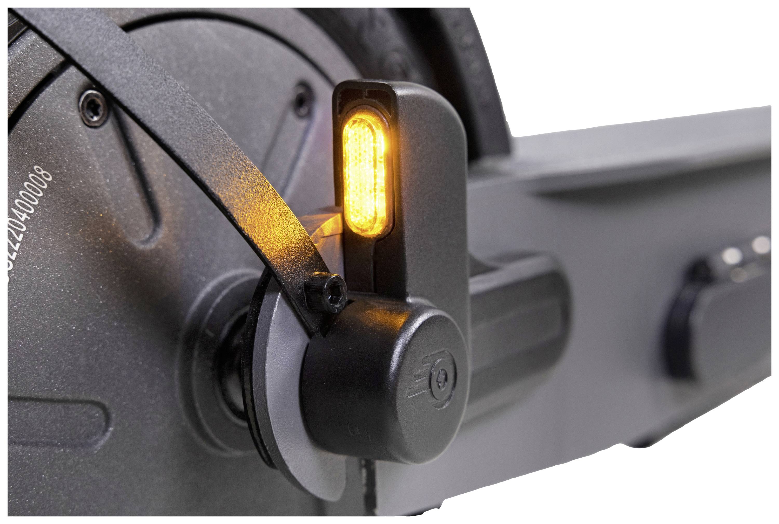 Close-up of a bicycle mudguard with an integrated yellow rear light, mounted on a suspension bicycle frame.