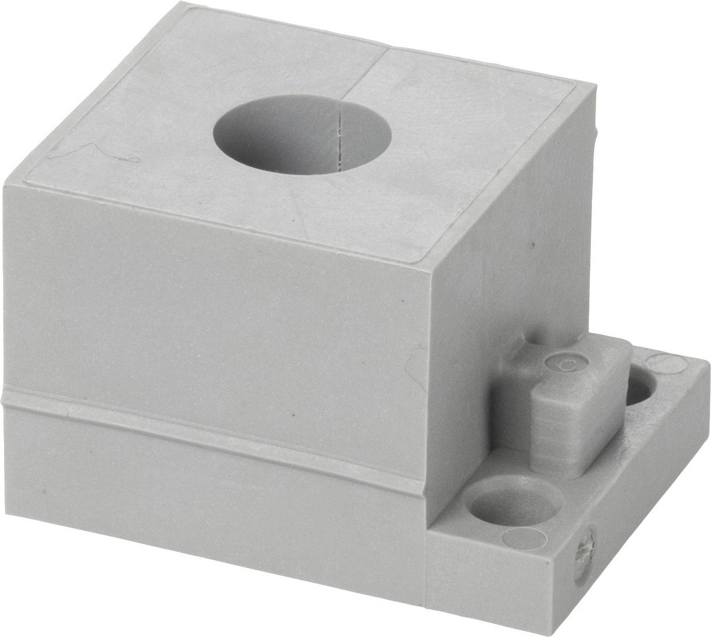 Grey plastic block component with a large, central circular hole and two additional openings on the side.