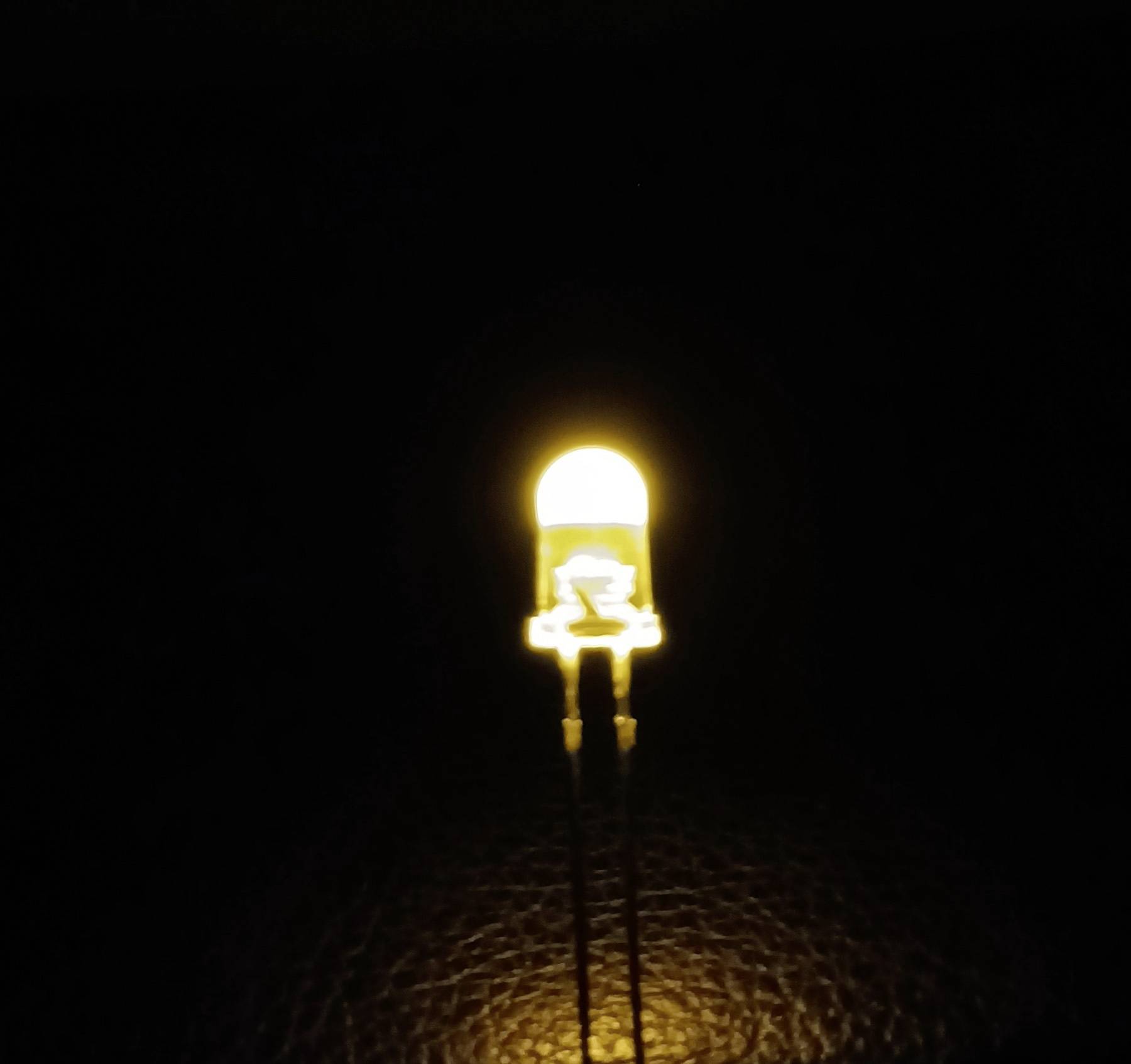 'A yellow LED glows in the darkness.'