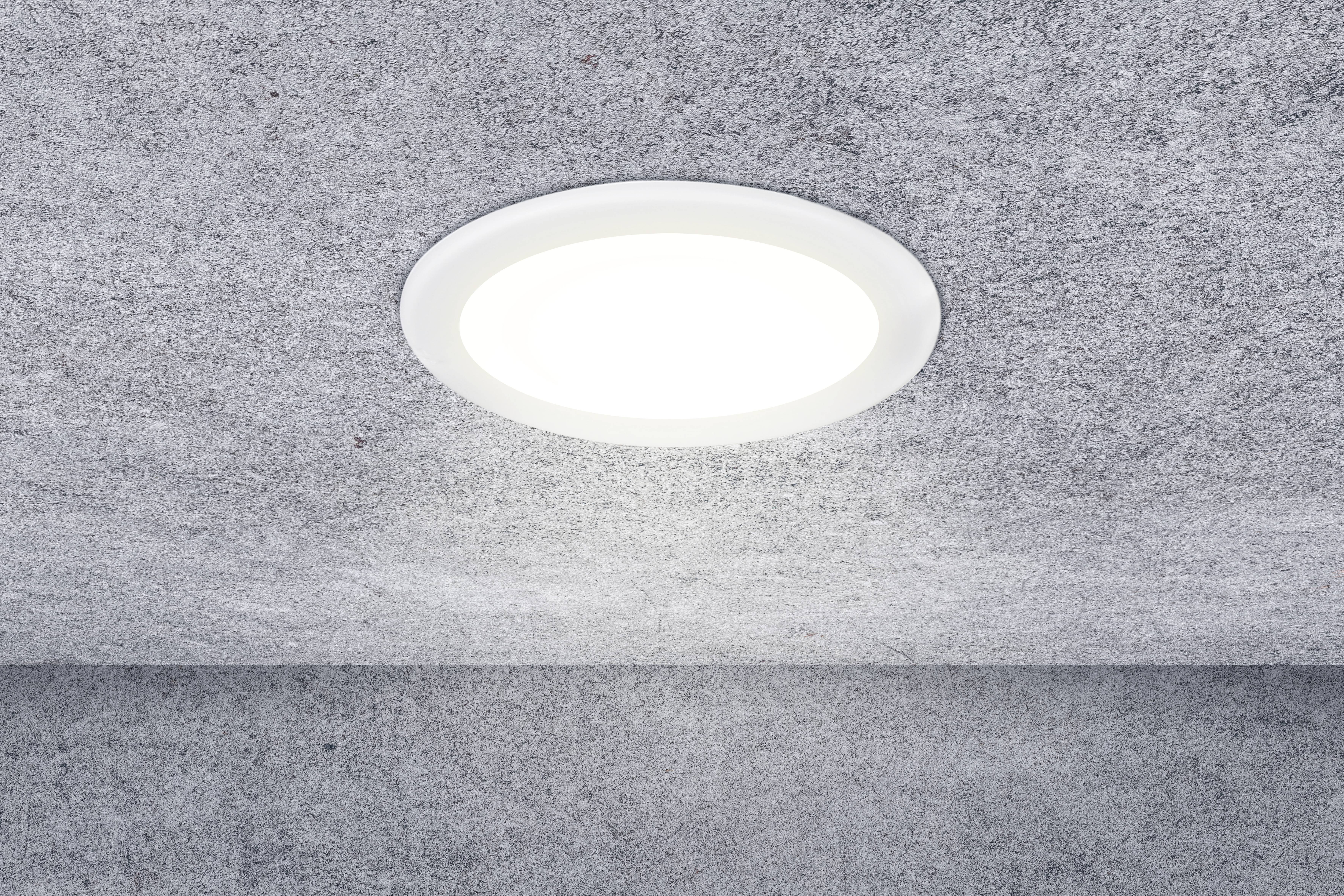 A round ceiling light is recessed into a grey, textured ceiling, providing even illumination throughout the room.