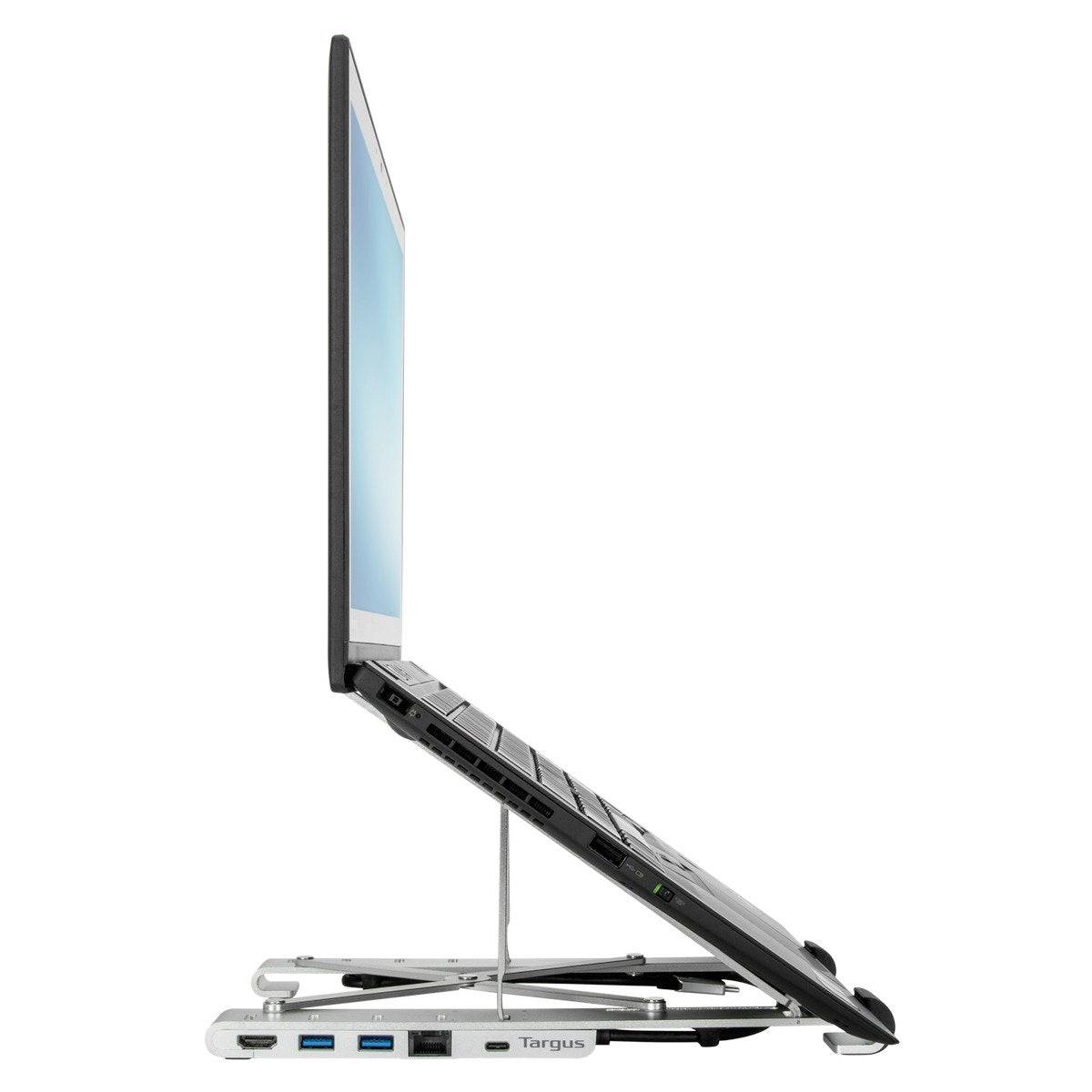 A raised laptop on an ergonomic stand shows the connection of multiple USB ports on the side.