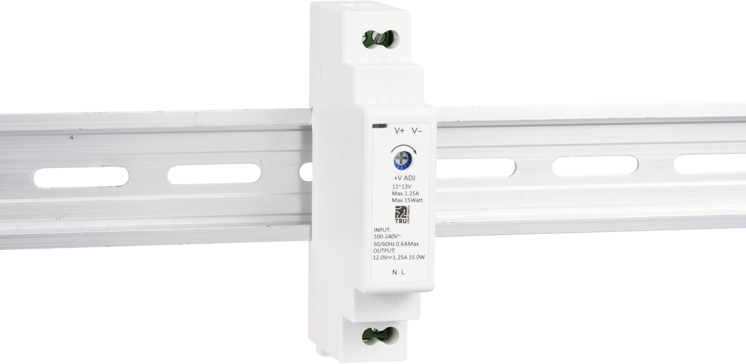 A white electronic device is mounted on a DIN rail. It has multiple ports and labels for voltage configuration.