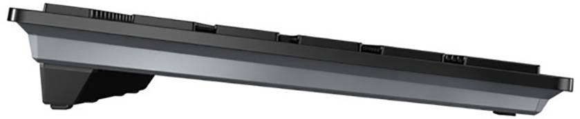 Black computer keyboard in side view with an angled height setting. Distinct elevation for ergonomic typing.