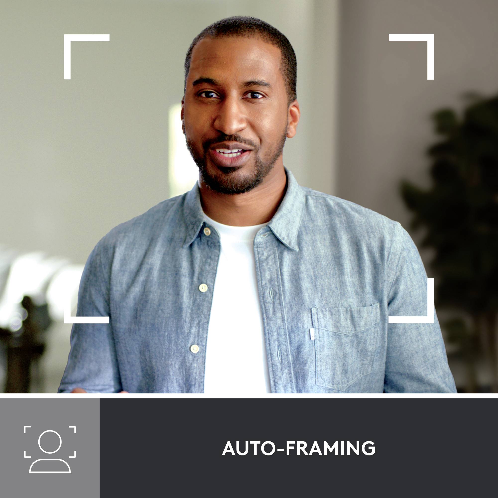 A person with a smiling face against a blurred background is framed by auto-framing technology.