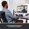 A man is sitting at a desk and having a video call with two women on a screen. Text: 'Communicating on an equal footing'.