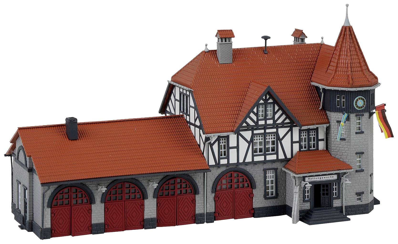 A model of a German fire station with half-timbered details and a red tiled roof. Two flags are hanging on the façade.