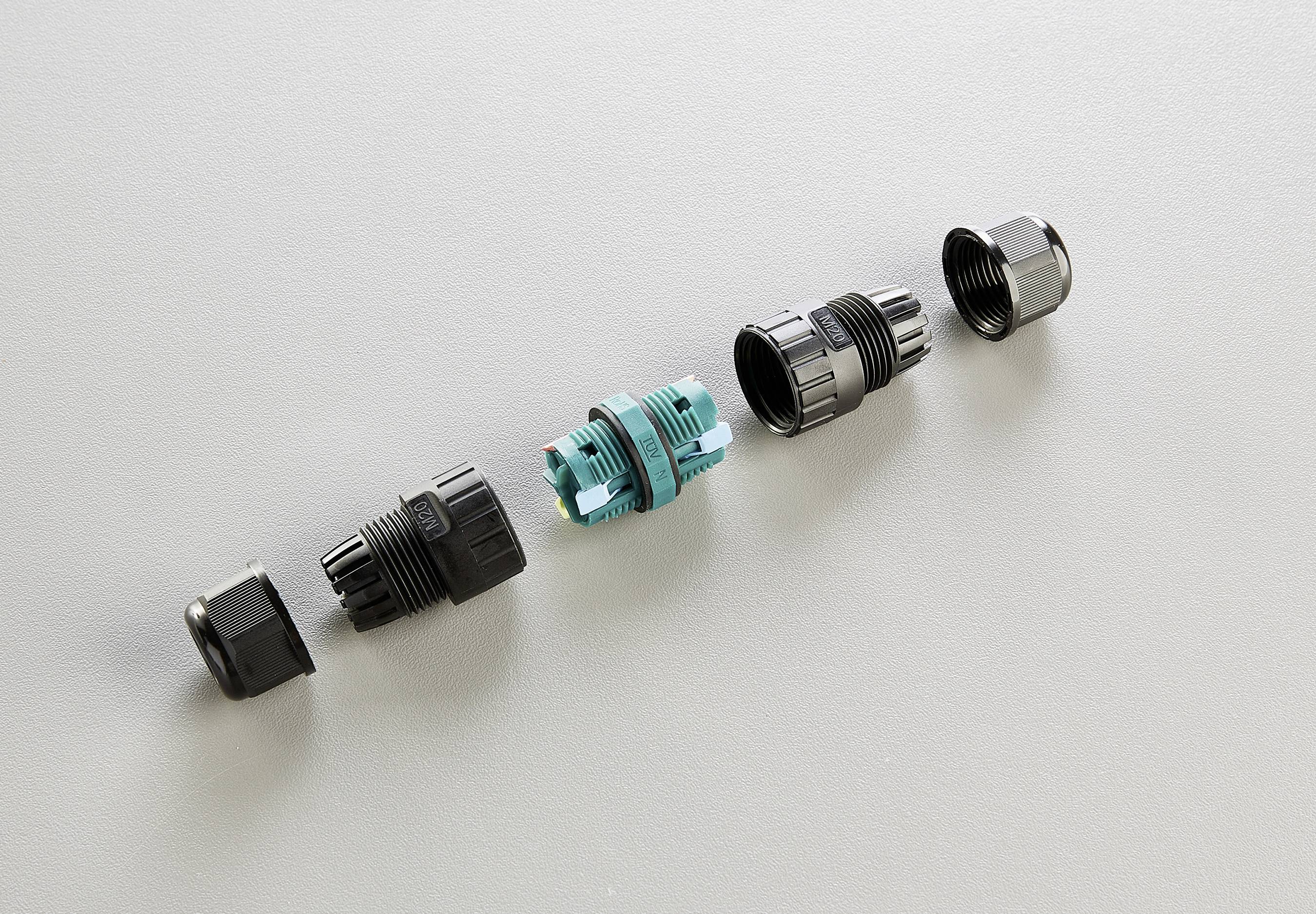 A cable entry system shows five components in a line: two black sockets, a blue central piece, and two screw closures.