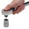 A hand holds a ratchet over a hexagon socket, ready to apply it.