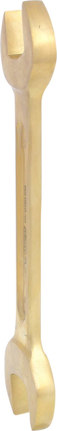 A golden adjustable spanner with open jaws at both ends, vertically positioned and gleaming.