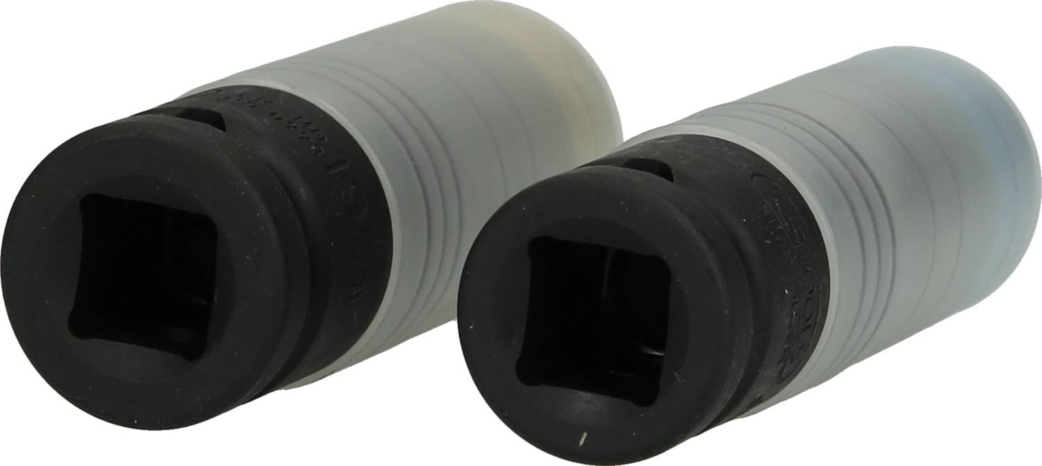Two black cylinders with rectangular openings, placed side by side on a white surface. They appear identical and have smooth surfaces.