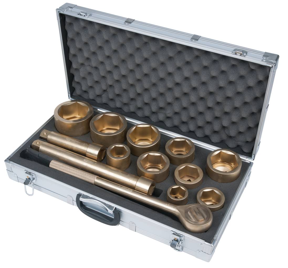 An open metal case with foam lining contains various tools and socket keys.