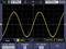 'Oscilloscope display shows a sinusoidal wave.'