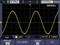 'Oscilloscope screen displays a yellow sine wave with a frequency of 999.9 Hz and a voltage of 12.00 V on Channel 1.'