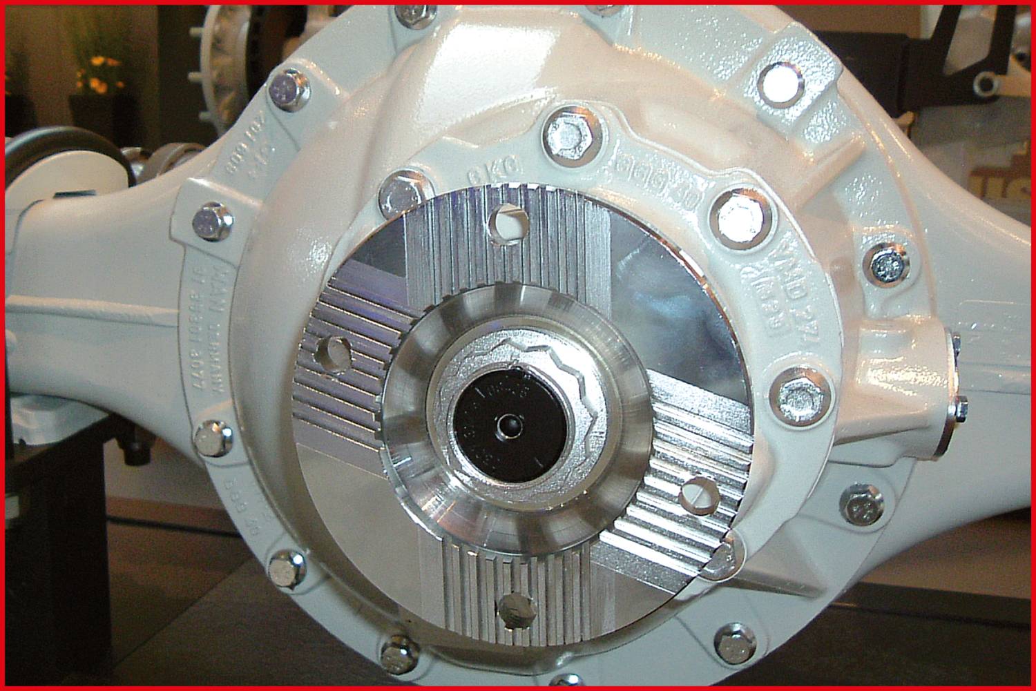 'Close-up of a mechanical component with visible screws and metal components; likely part of a vehicle differential.'