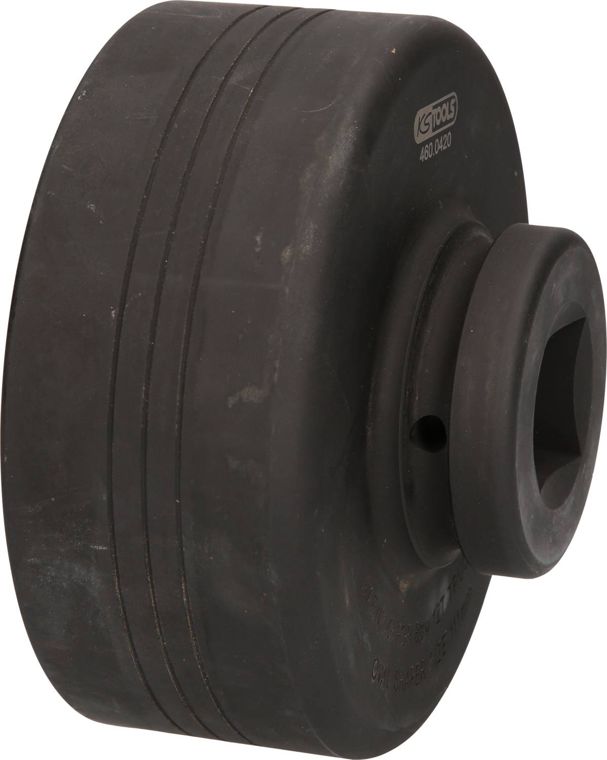 A massive, black metal tool with a cylindrical shape, featuring a square hole in the centre.