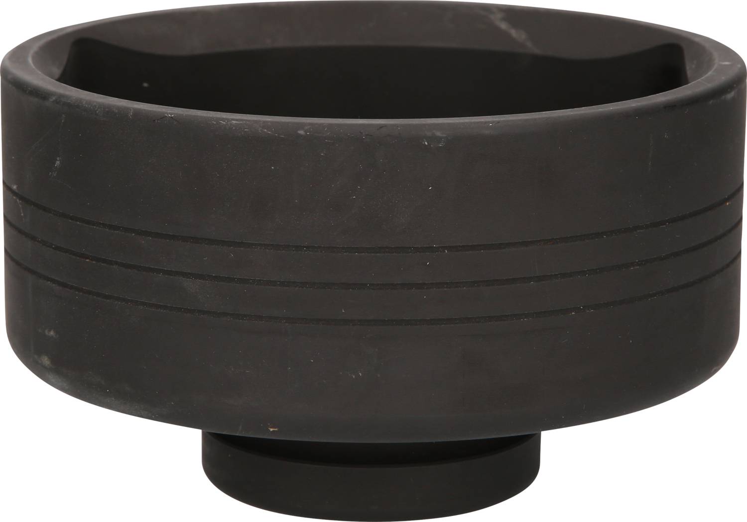 A black, round rubber dish with ridged lines on the outside. Likely used in printing or for laboratory purposes.