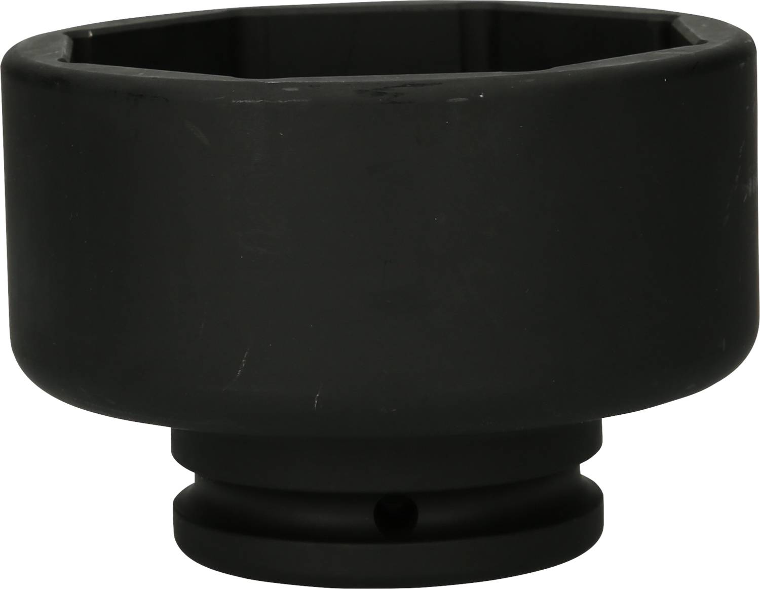 Black metal oil filter tool adapter, round with a hexagonal inner edge, used for removing oil filters in vehicles.