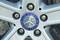 Car tyre with a Mercedes-Benz wheel rim. In the centre is the Mercedes logo, surrounded by five wheel nuts.