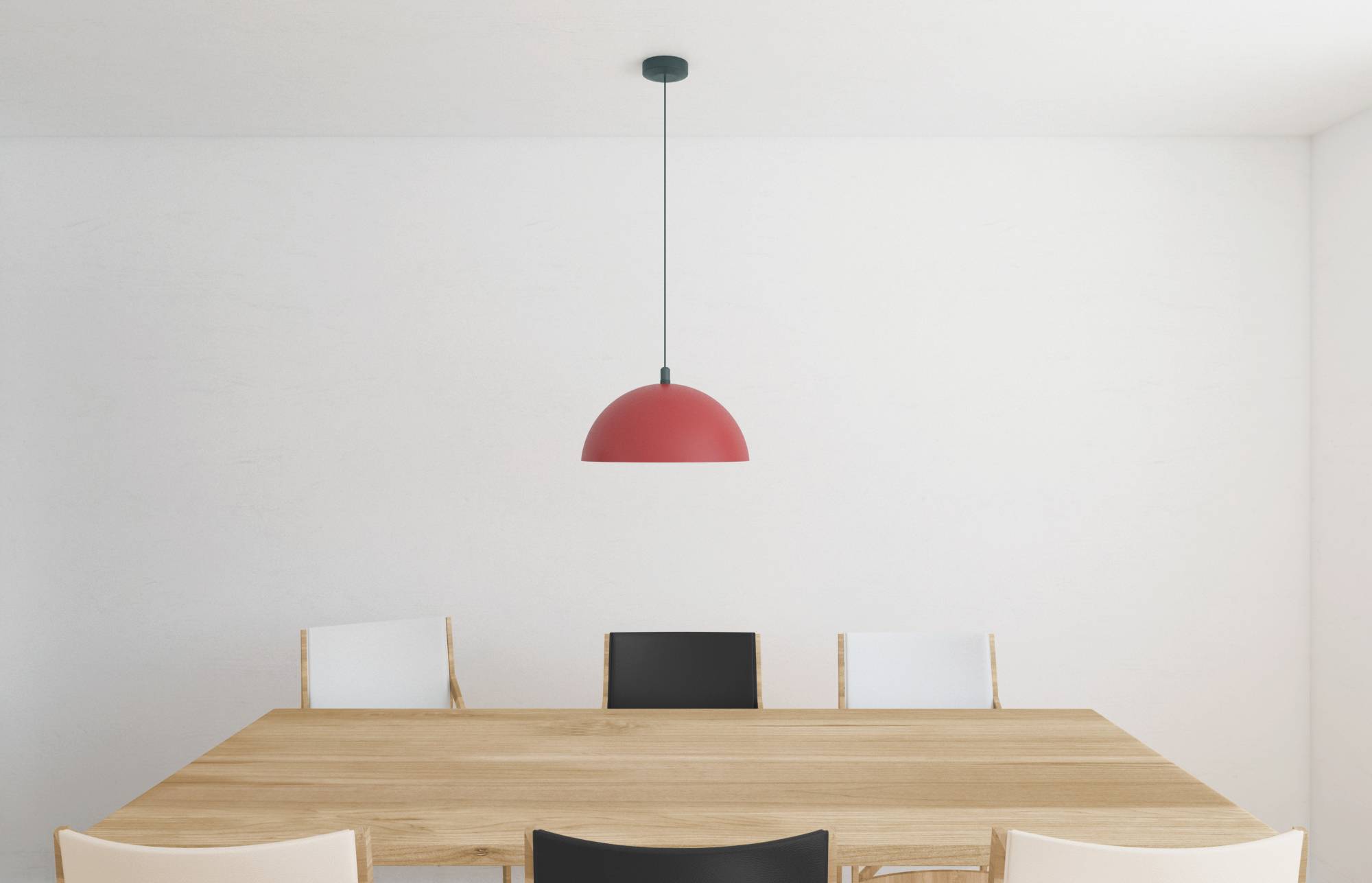 A wooden dining table with four chairs, two black and two white, is centered under a red pendant light in a minimalist room.