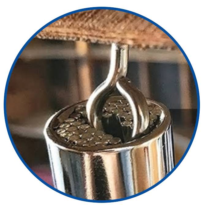 Close-up of a silver zip being opened. The shiny metallic surface is visible.