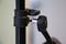 'Close-up of a black tripod screw clamp with a silver rotary connection'