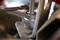 A silver spanner turns a nut on a metal bracket. Mechanical work in focus.