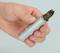 A hand is holding a silver spark plug, an important automotive component used to ignite fuel in the engine.