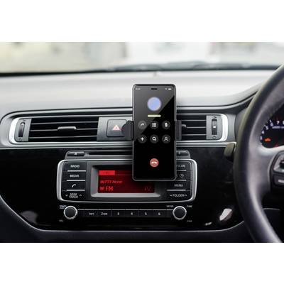A smartphone is mounted on the dashboard of a car and displays an active call screen. Below it is the car radio.