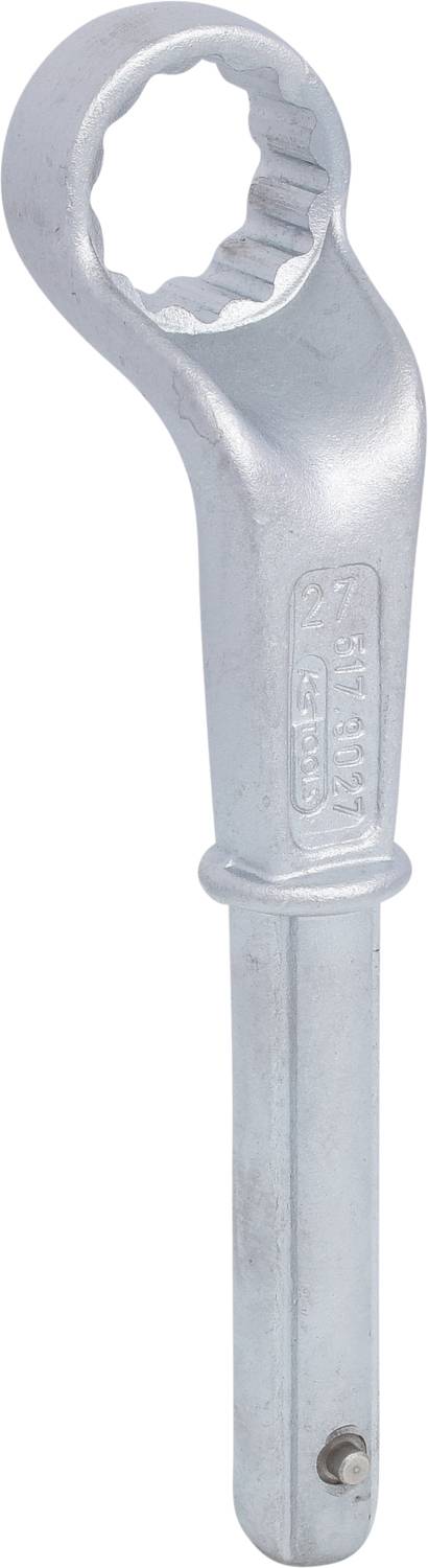 A silver ring key with a serrated handle and a round, toothed head.